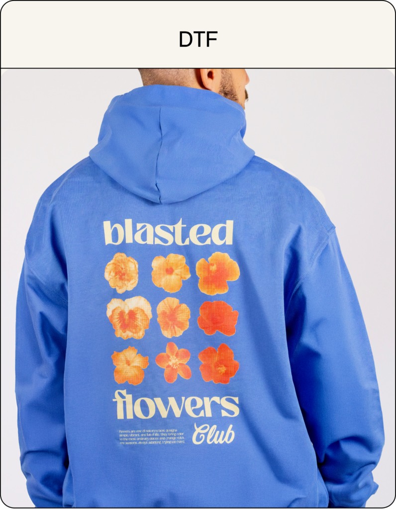 Hoodie bleu personnalisé en impression DTF avec visuel fleurs et typographie vintage, marquage textile haute définition pour marque streetwear.